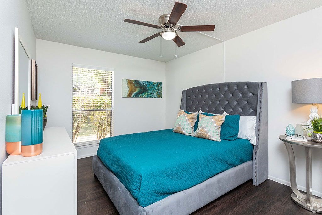 a bedroom with a bed and a ceiling fan  at Sunset Canyon, San Antonio, 78232