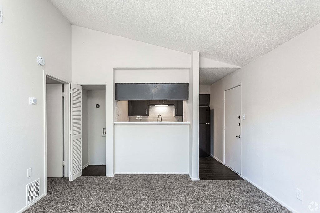 an empty room with a kitchen in the background  at Sunset Canyon, San Antonio, TX