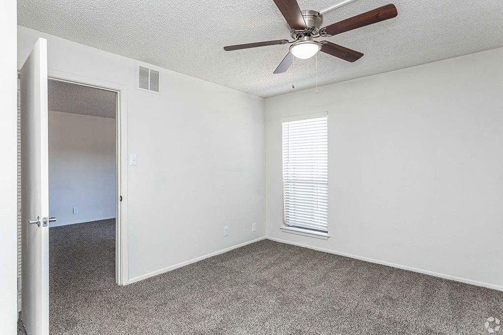 an empty bedroom with a ceiling fan  at Sunset Canyon, San Antonio, TX