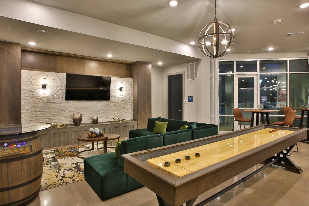 a living room with a pool table and a television at The Grand at Stonecreek, Texas