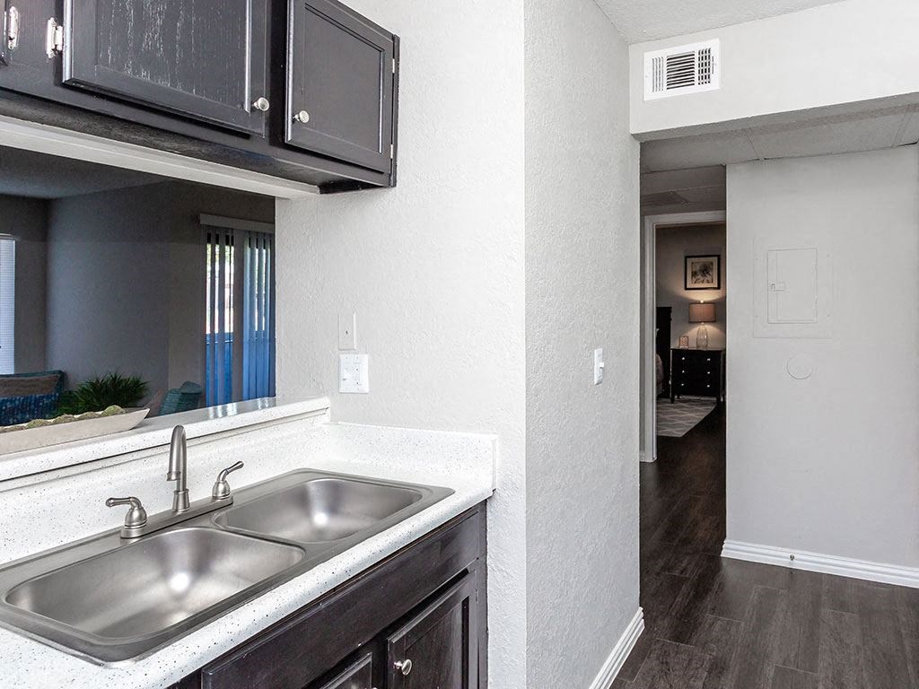 a kitchen with a sink and a window and a hallway