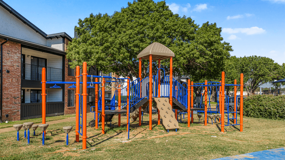 A playground with a slide, swings, and a climbing frame.