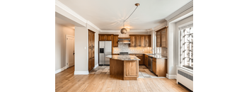 A kitchen with wooden cabinets and a central island.