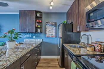a kitchen with stainless steel appliances and granite counter tops