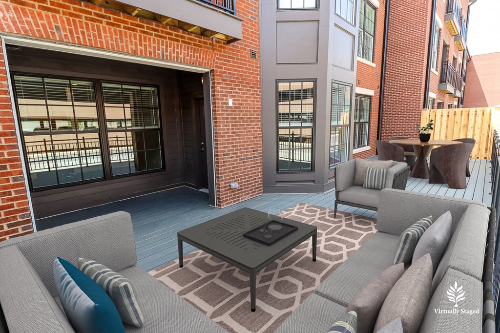 a patio with couches and a coffee table