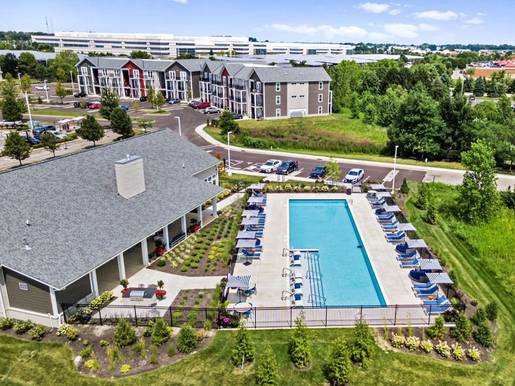A large building with a pool in front of it.