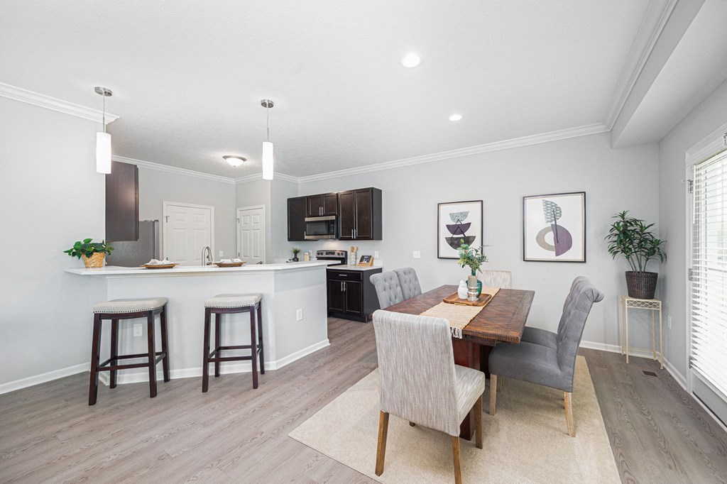 a dining room and kitchen with a table and chairs