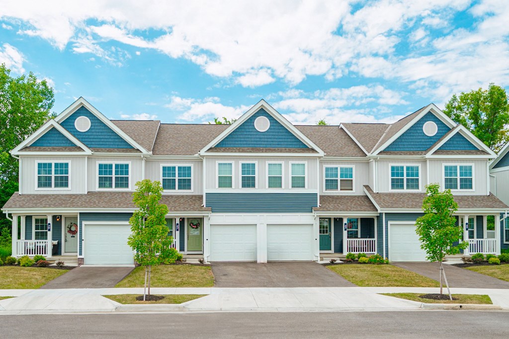 a large house with blue siding and white doors