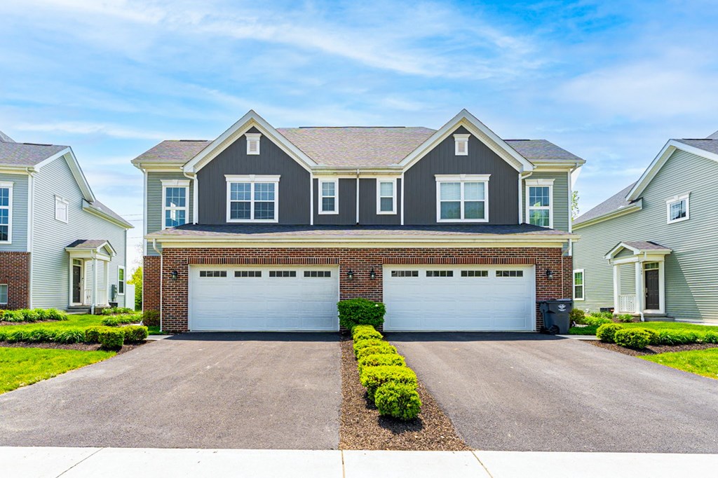 A two-car garage is in front of a house.