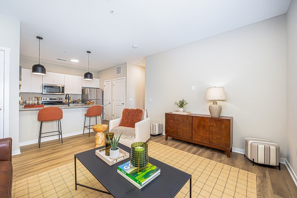 A living room with a black coffee table and a brown cabinet.