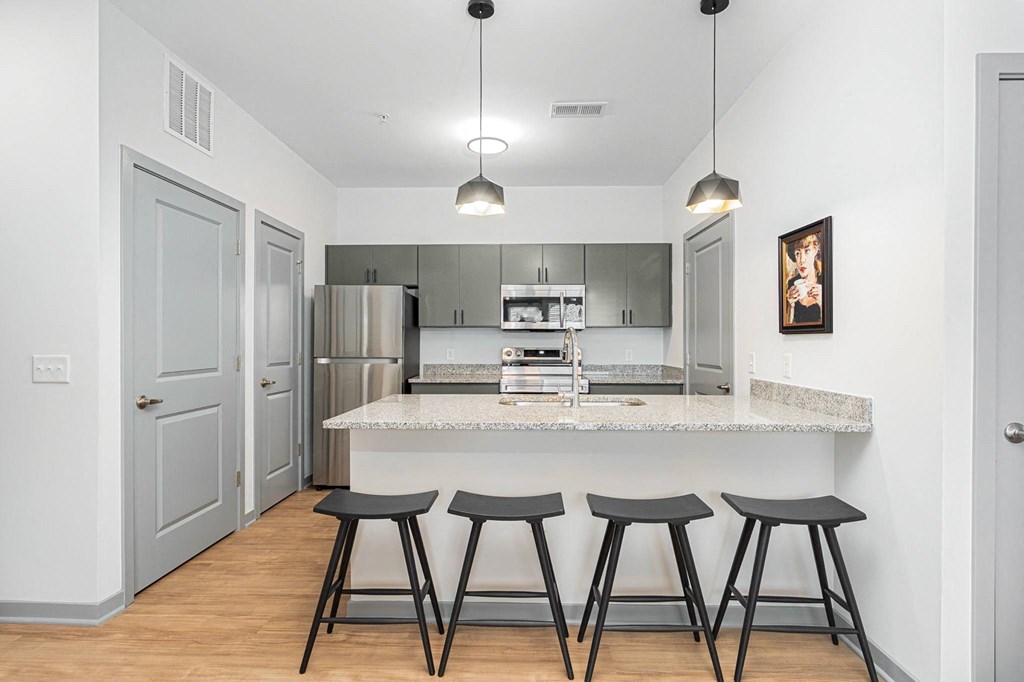 a kitchen with a counter top and three stools