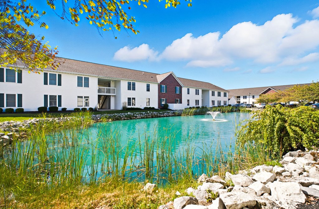 A row of houses with a body of water in front.