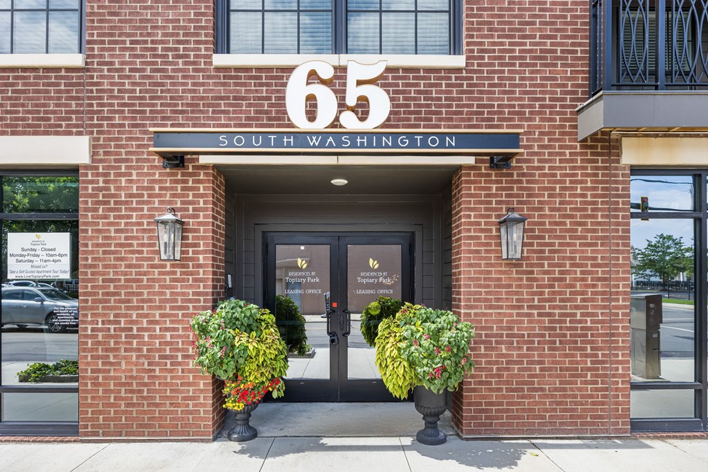 The front of a building with the number 65 and the words South Washington on it.