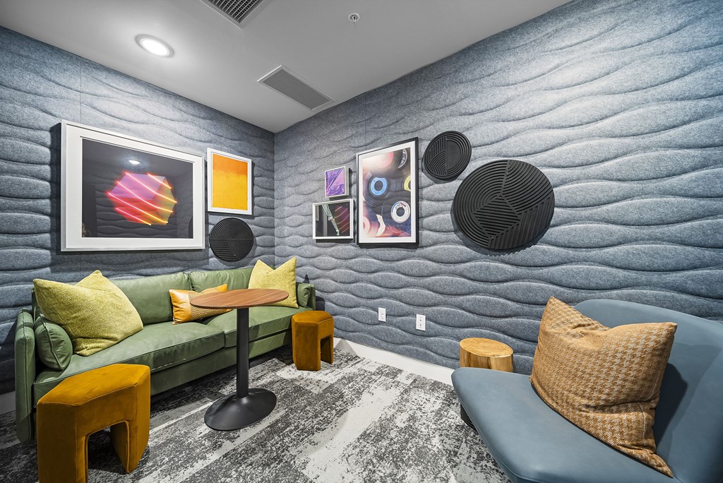 A living room with a blue couch and a green couch.