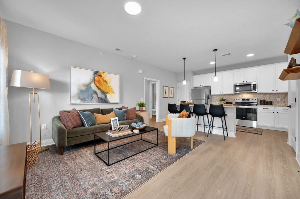A modern living room with a couch, chairs, and a coffee table.