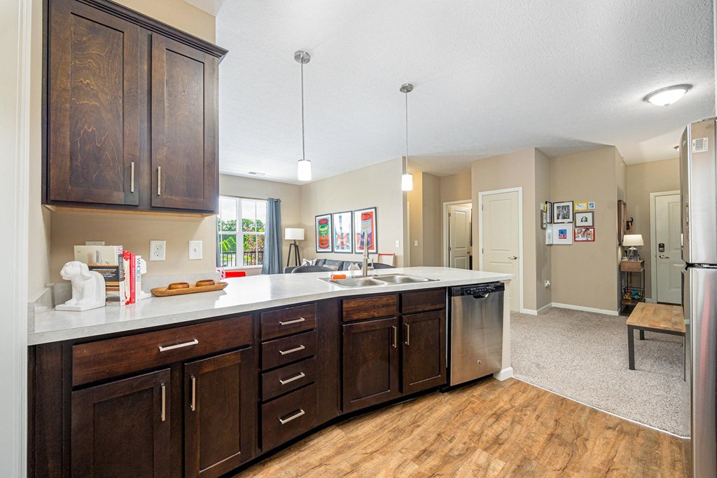 a kitchen with wooden cabinets and a white counter top
