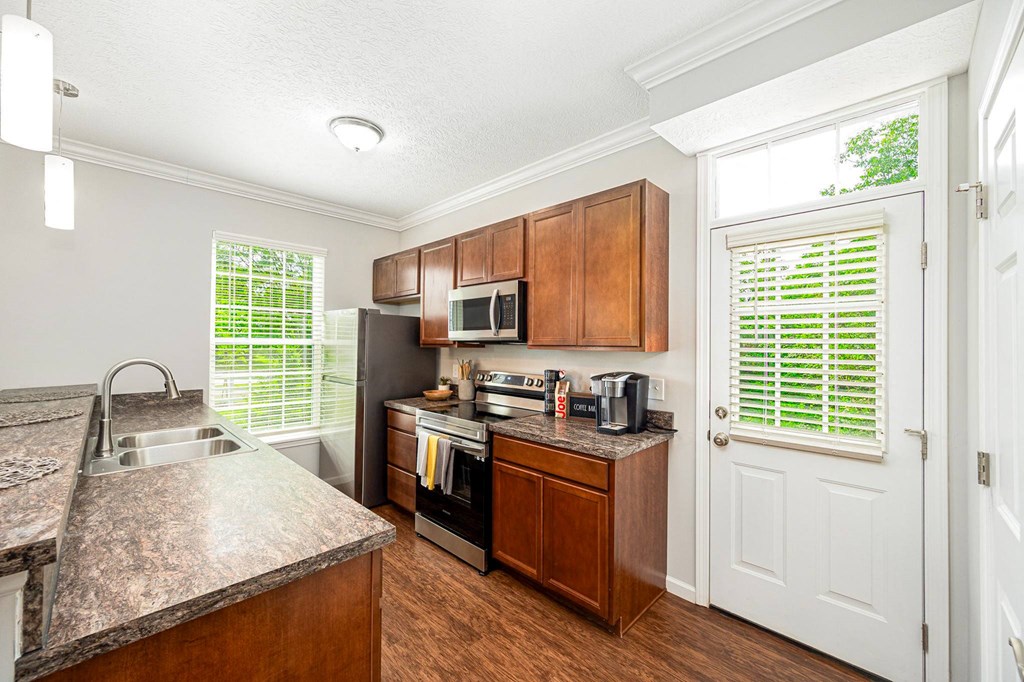 a kitchen with stainless steel appliances and wooden cabinets