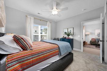 A bedroom with a bed, a dresser, and a mirror.