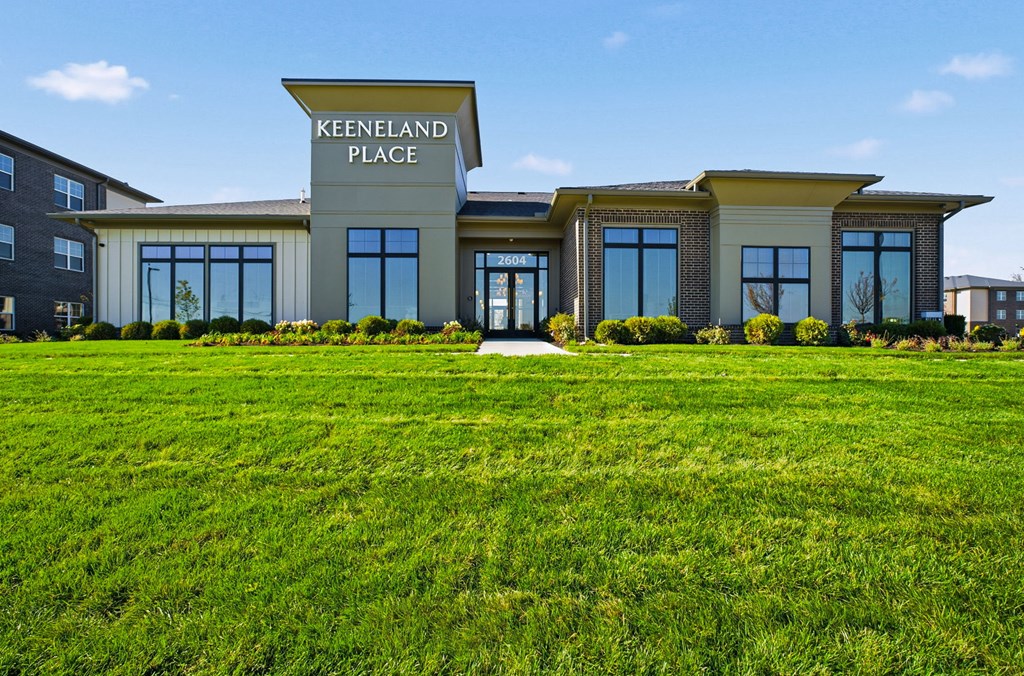 Keenland Place is a modern building with a green lawn in front.