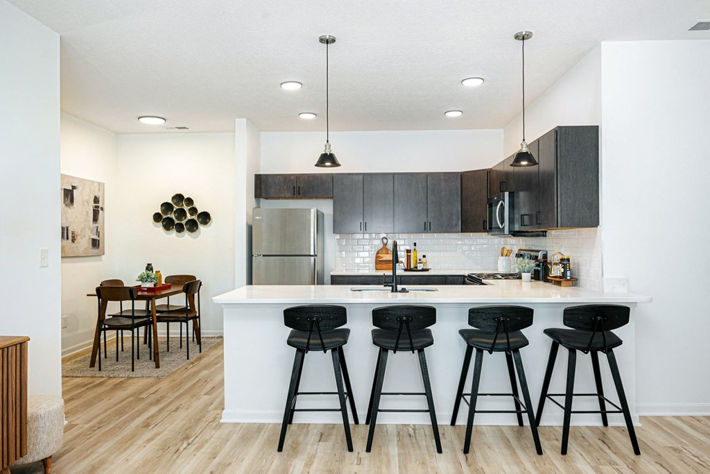 a kitchen with a large island with bar stools
