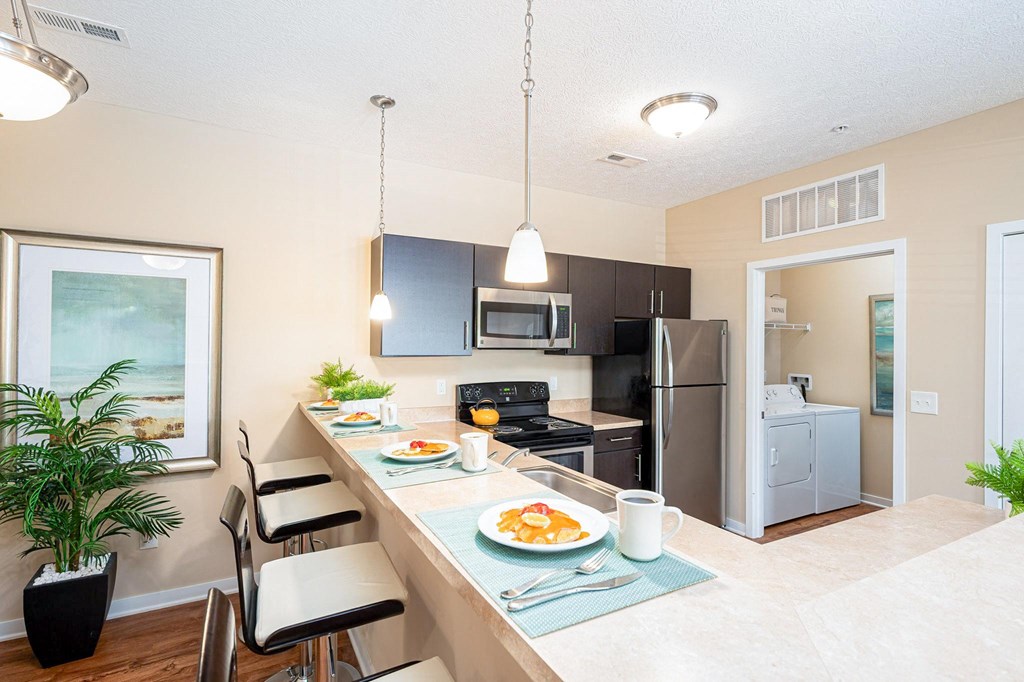 a kitchen with a long counter with plates of food