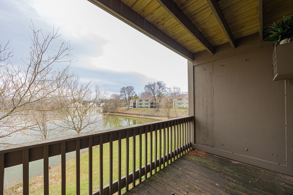 A balcony with a view of a river and buildings.