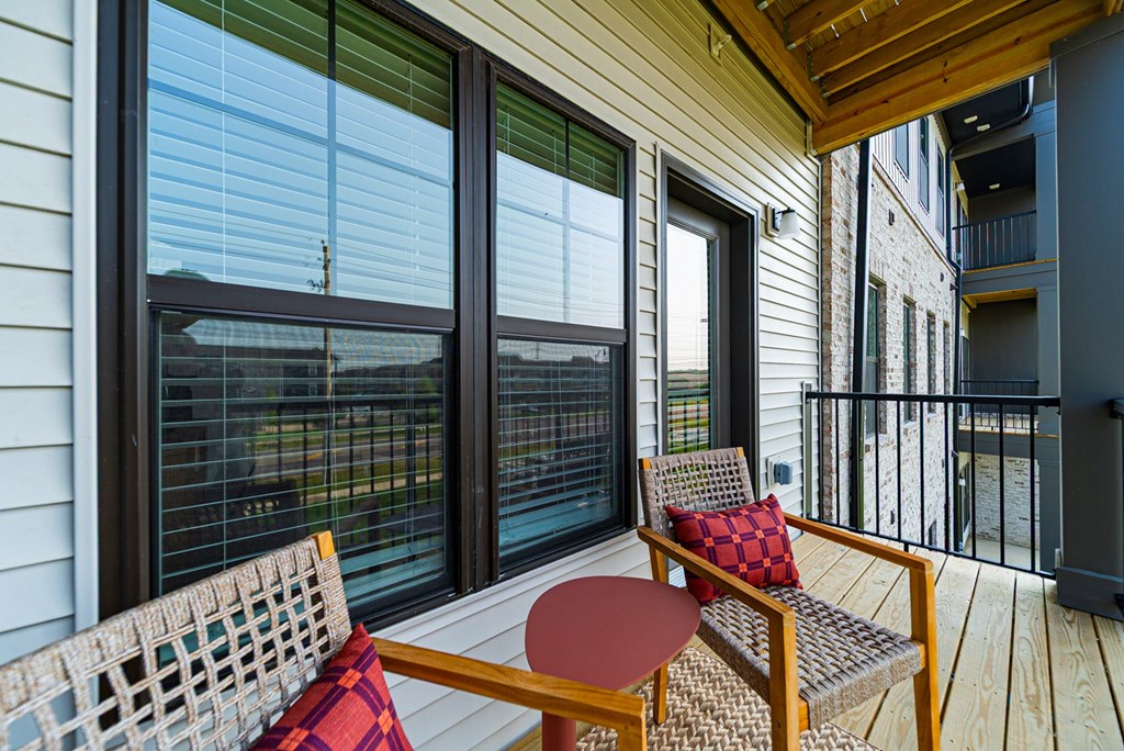 A wooden table and chair set on a balcony.