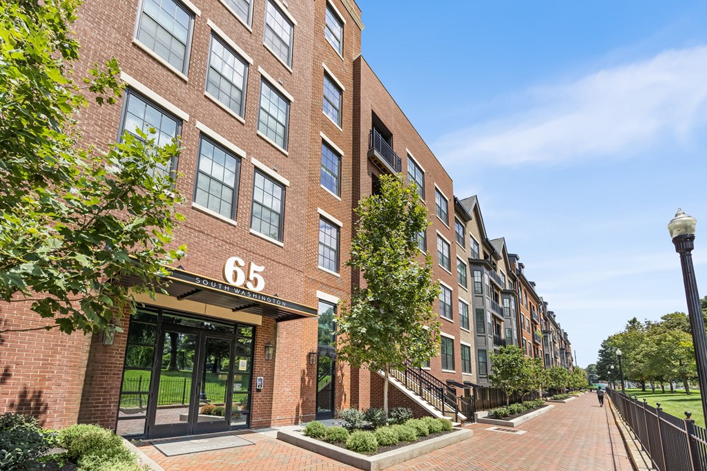 A brick building with the number 65 on it.