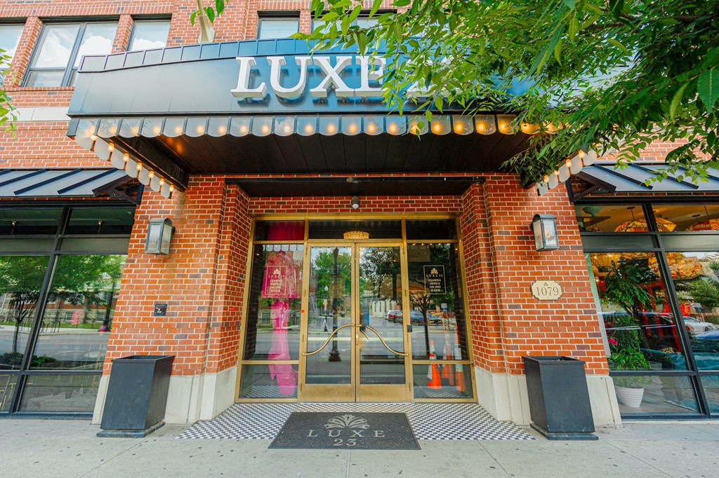 the exterior of luxe luxe restaurant with a brick facade and glass doors