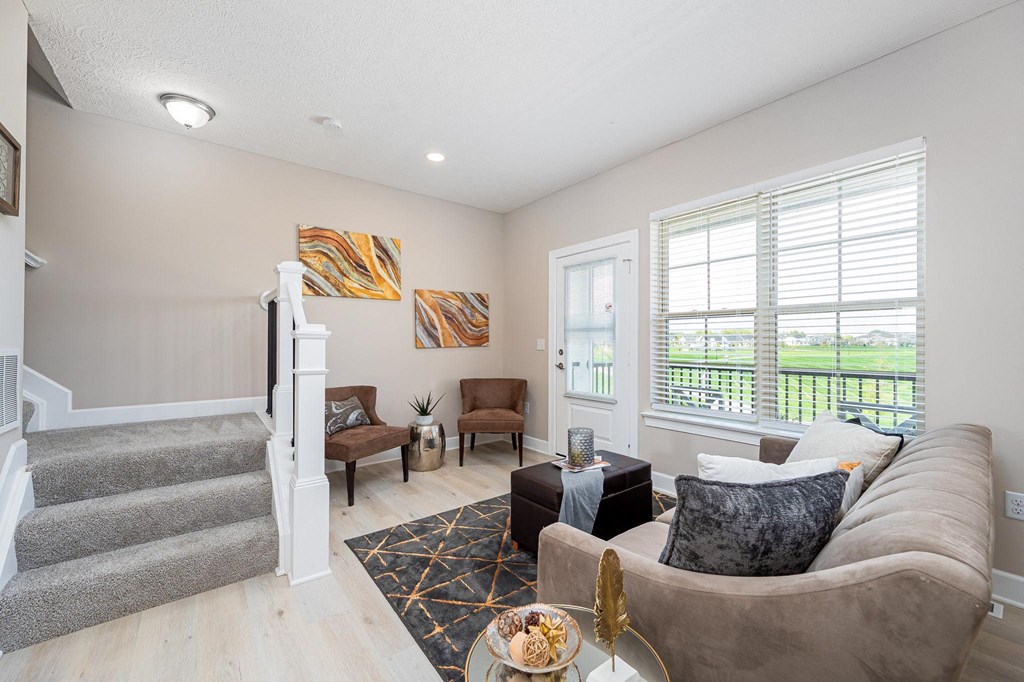 a living room with a staircase and a couch