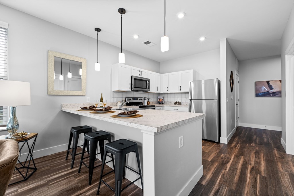 A kitchen with a white countertop and a refrigerator.