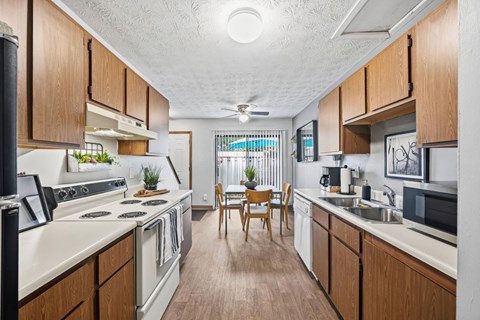 A kitchen with wooden cabinets and a white countertop.