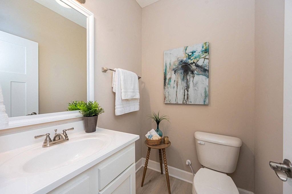 a bathroom with a sink toilet and a mirror
