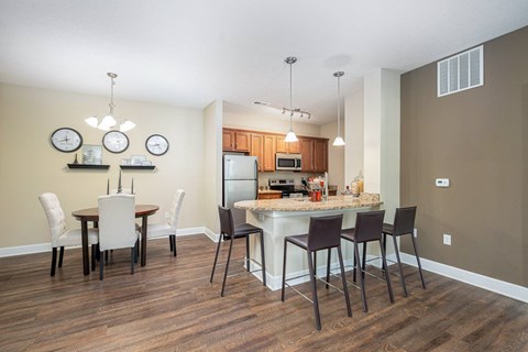 an open kitchen and dining area with a marble counter top