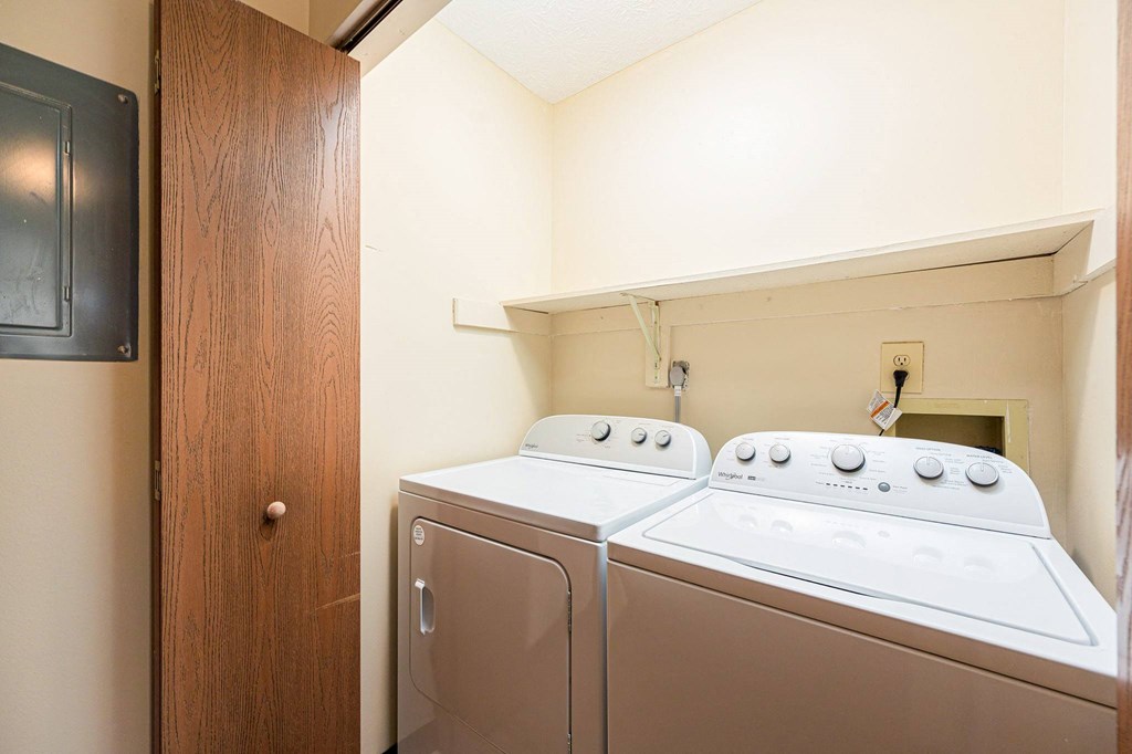a washer and dryer in a laundry room with a door