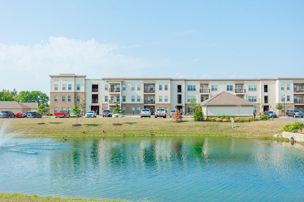 an image of an apartment building overlooking a lake