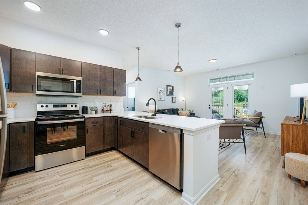 a large kitchen with wooden cabinets and stainless steel appliances