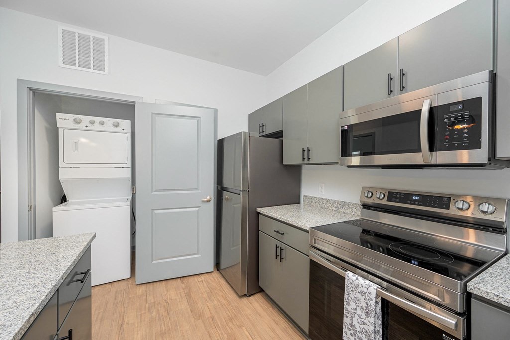 a kitchen with stainless steel appliances and granite counter tops