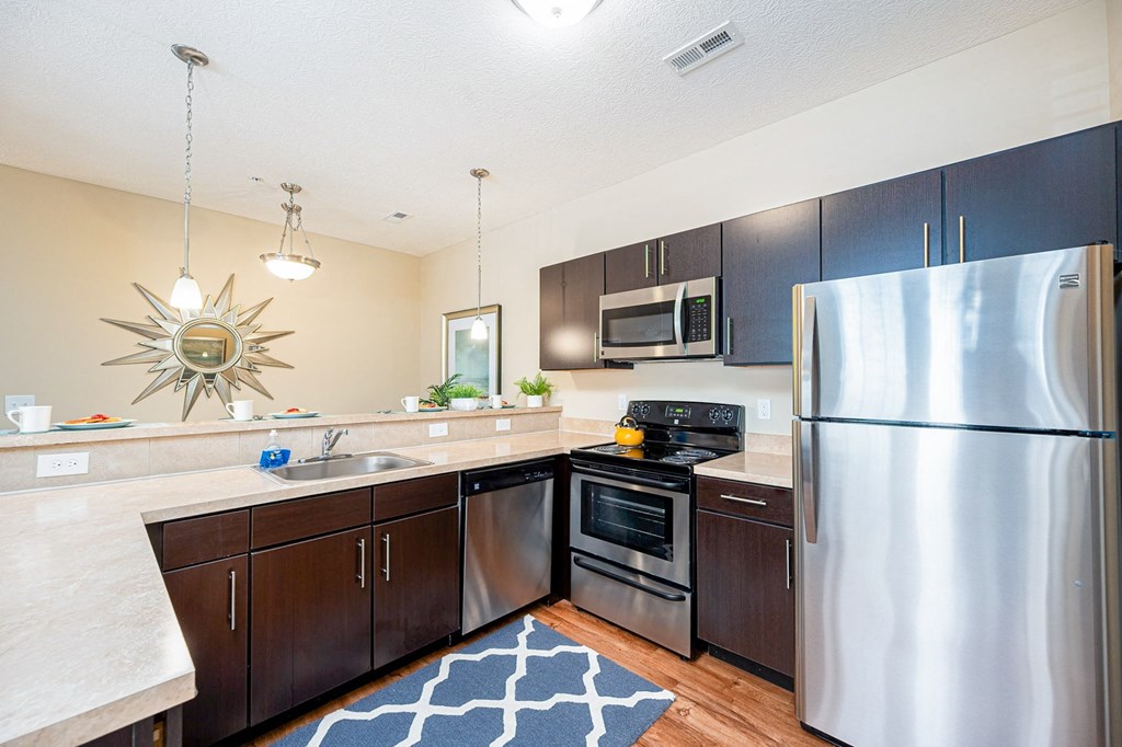 full kitchen with stainless steel appliances at the reserve at walnut creek apartments