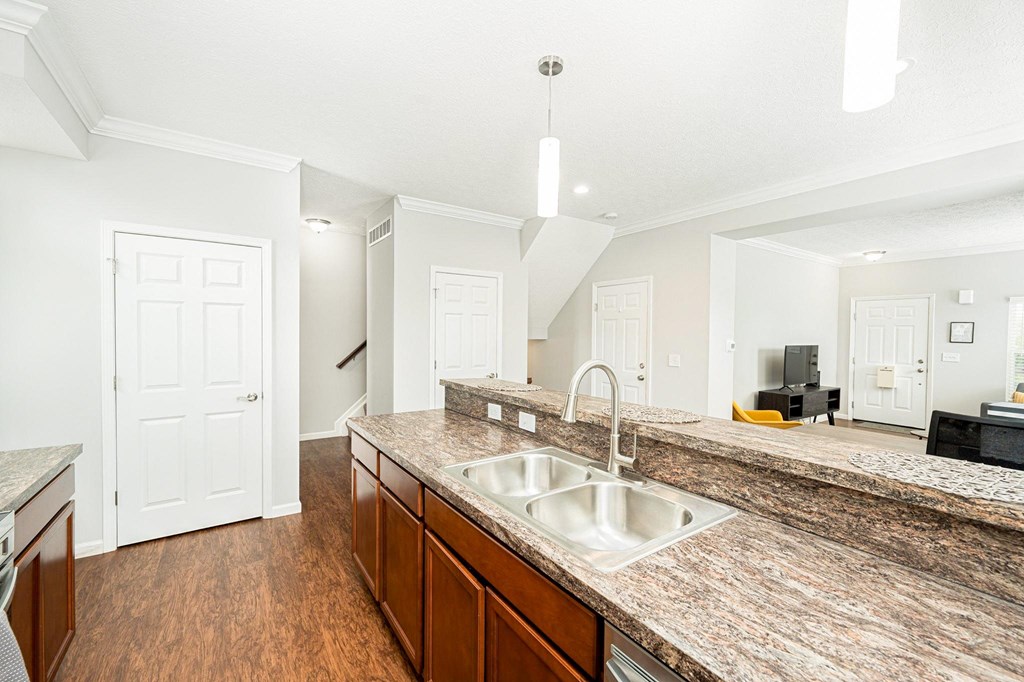 a large kitchen with a sink and a counter top