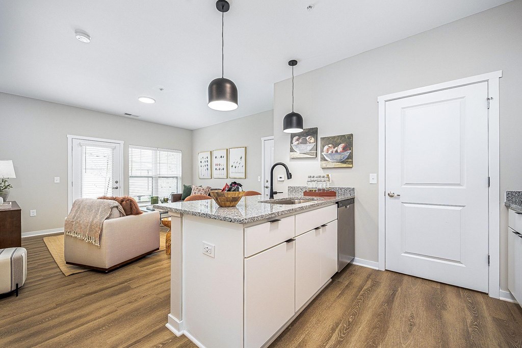 A modern kitchen with white cabinets and a central island.