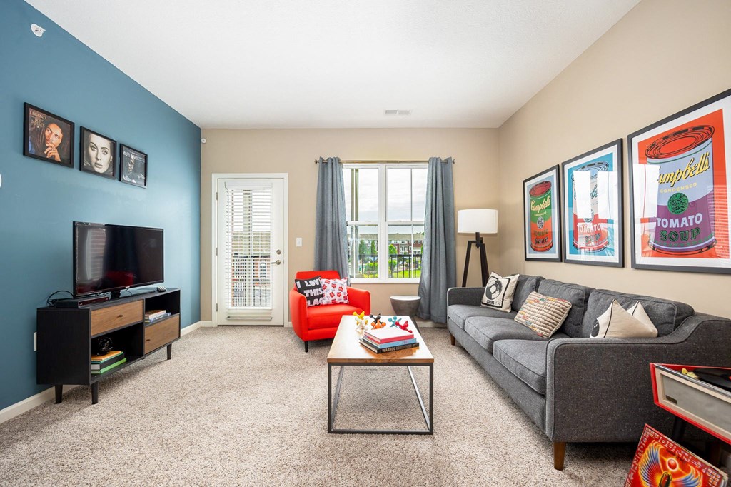 a living room with a couch and a coffee table and a television