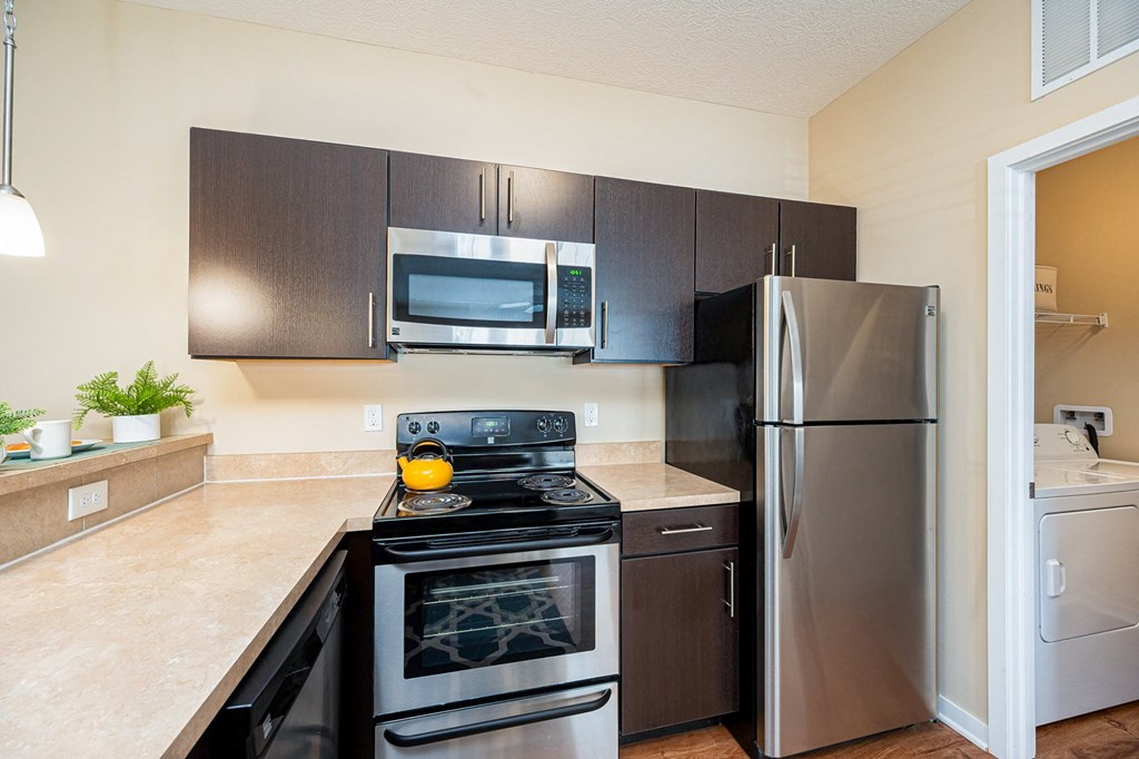 a kitchen with stainless steel appliances and a stainless steel refrigerator