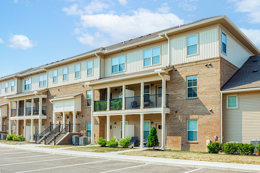 a brick apartment building with balconies and stairs