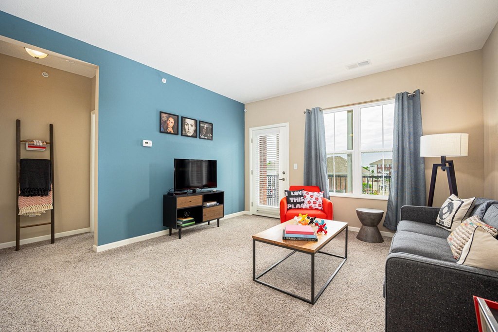 a living room with a blue wall and a couch and a table