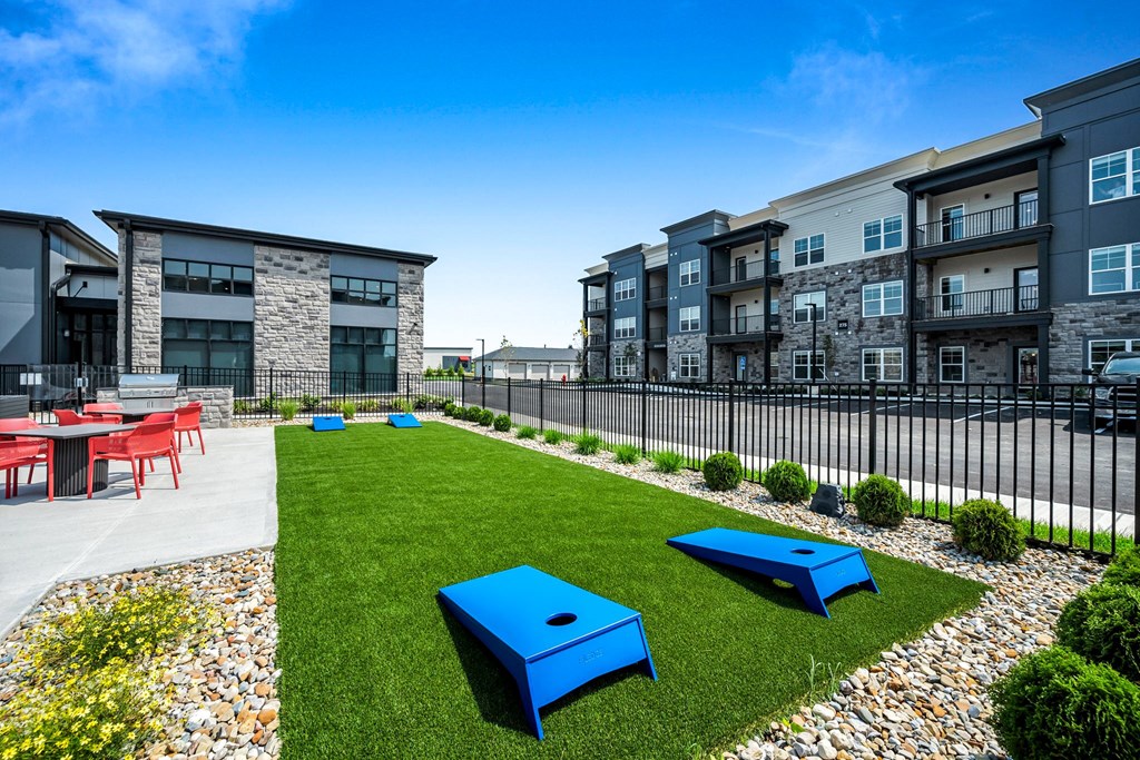 A modern outdoor seating area with blue benches and tables.