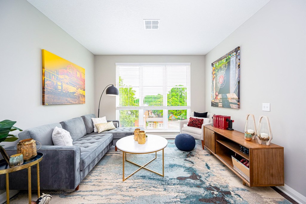 a living room with a gray couch and a coffee table