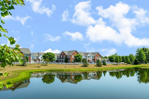 the view of a building reflected in a pond