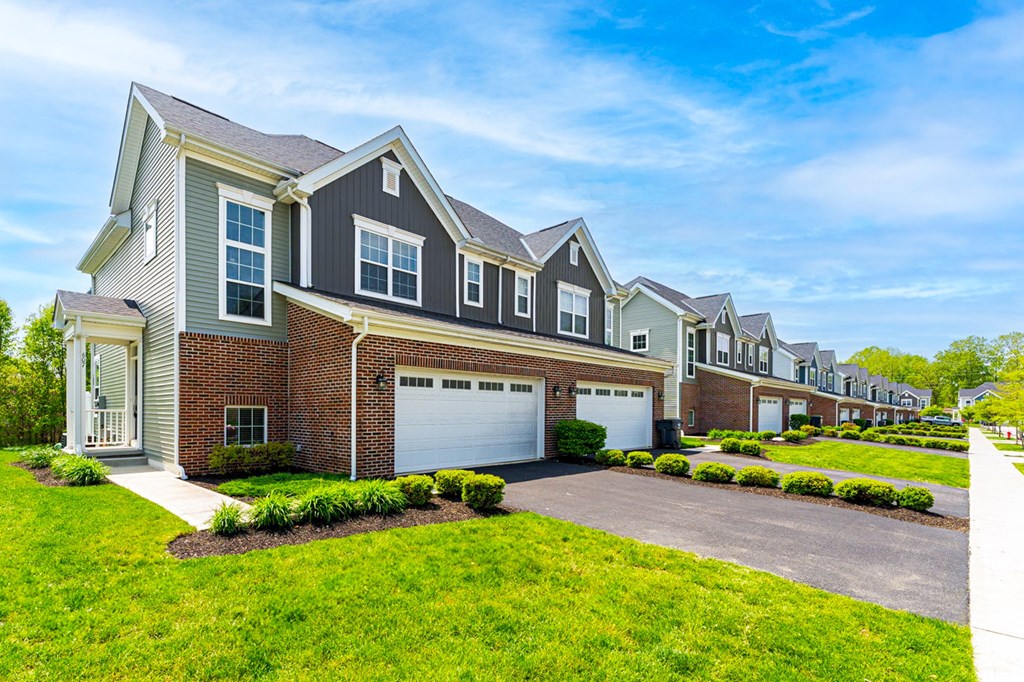 A row of houses with a clear blue sky above them.