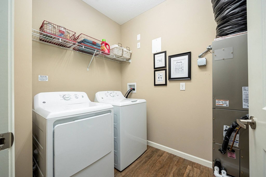 a washer and dryer in a laundry room with a door to a closet